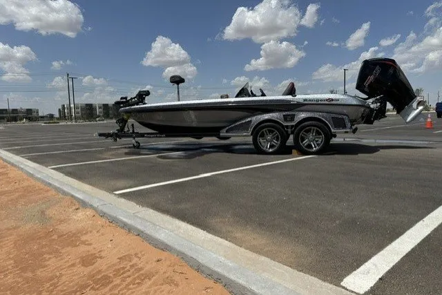 The Image of 2026 Ranger Z520 boat on trailer in sunny parking lot. - 0