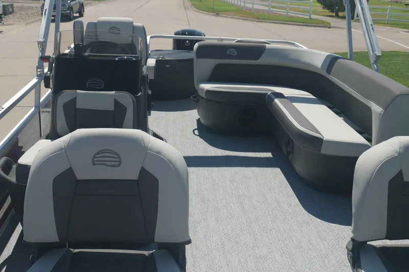 Slide: The Image of 2026 Sun Tracker Bass Buggy 18 DLX pontoon boat interior with seating and helm. - 4
