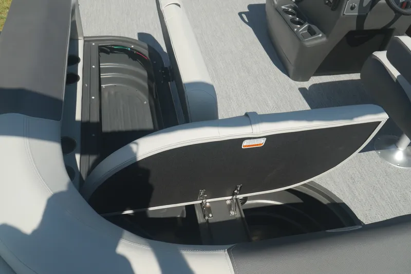 Slide: The Image of 2026 Sun Tracker Bass Buggy 18 DLX boat interior with open storage compartment. - 10