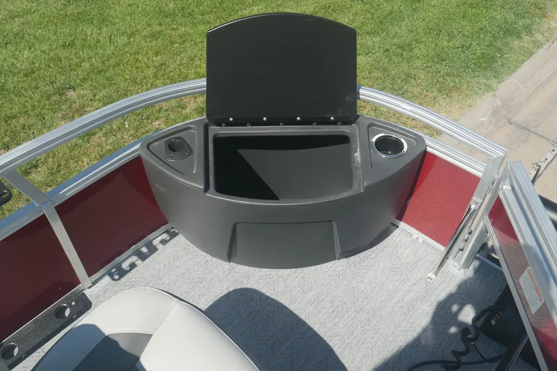 Slide: The Image of 2026 Sun Tracker Bass Buggy 18 DLX boat interior with storage compartment and cup holders. - 6