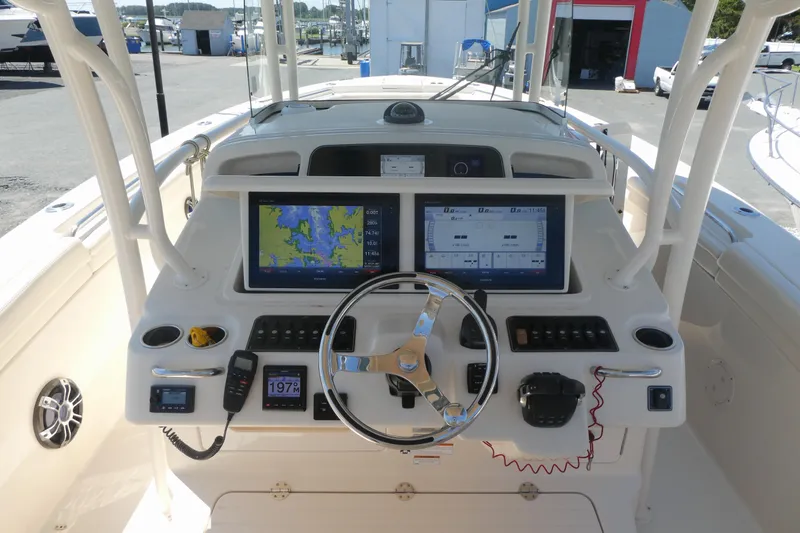Slide: The Image of 2019 Grady-White Canyon 336 helm with dual displays and navigation controls. - 5