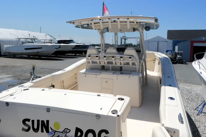 Slide: The Image of 2019 Grady-White Canyon 336 boat docked, featuring spacious deck and seating area. - 2