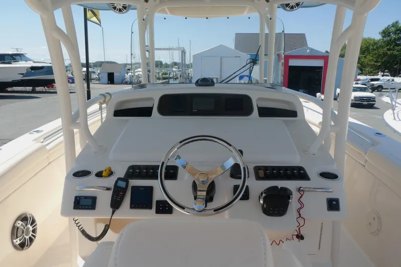 Slide: The Image of 2019 Grady-White Canyon 336 boat helm with steering wheel and control panel. - 4