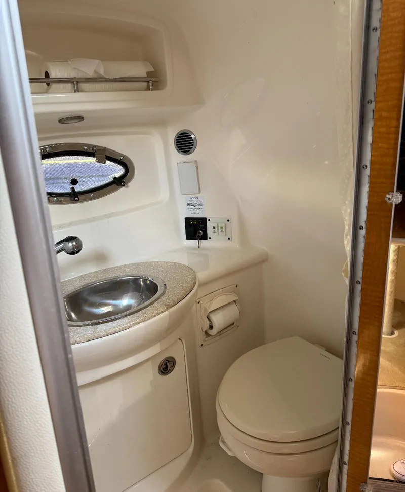 Slide: The Image of 2006 Chaparral Signature 276 boat bathroom with sink and toilet. - 9