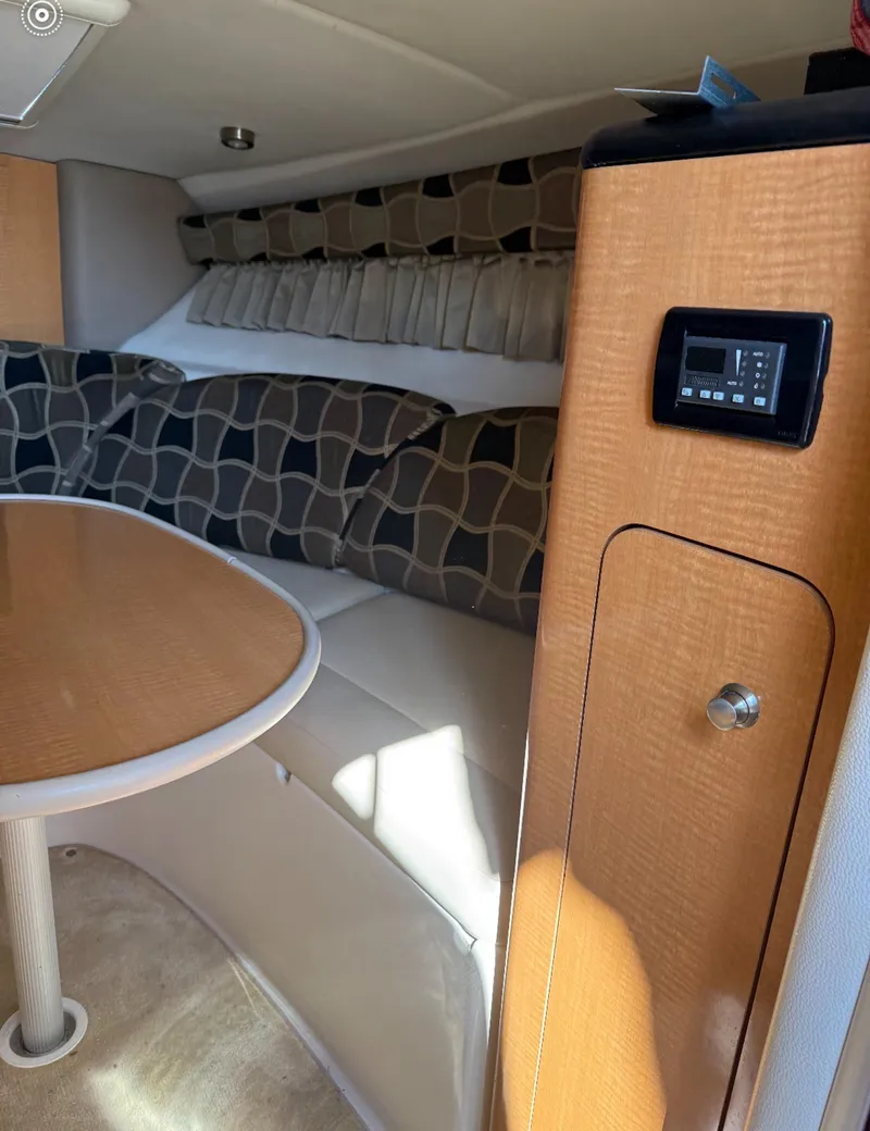 Slide: The Image of Interior of 2006 Chaparral Signature 276 boat with modern seating and wood finish. - 7
