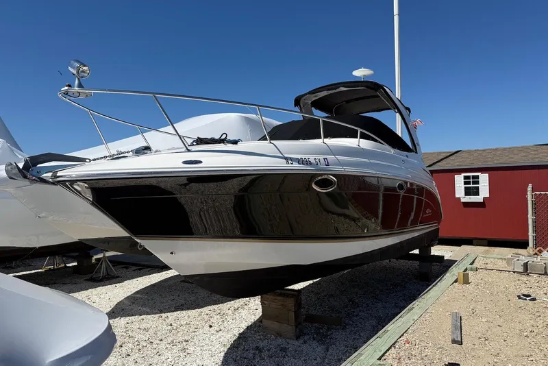 Slide: The Image of 2006 Chaparral Signature 276 boat on dry dock, with clear blue sky background. - 1