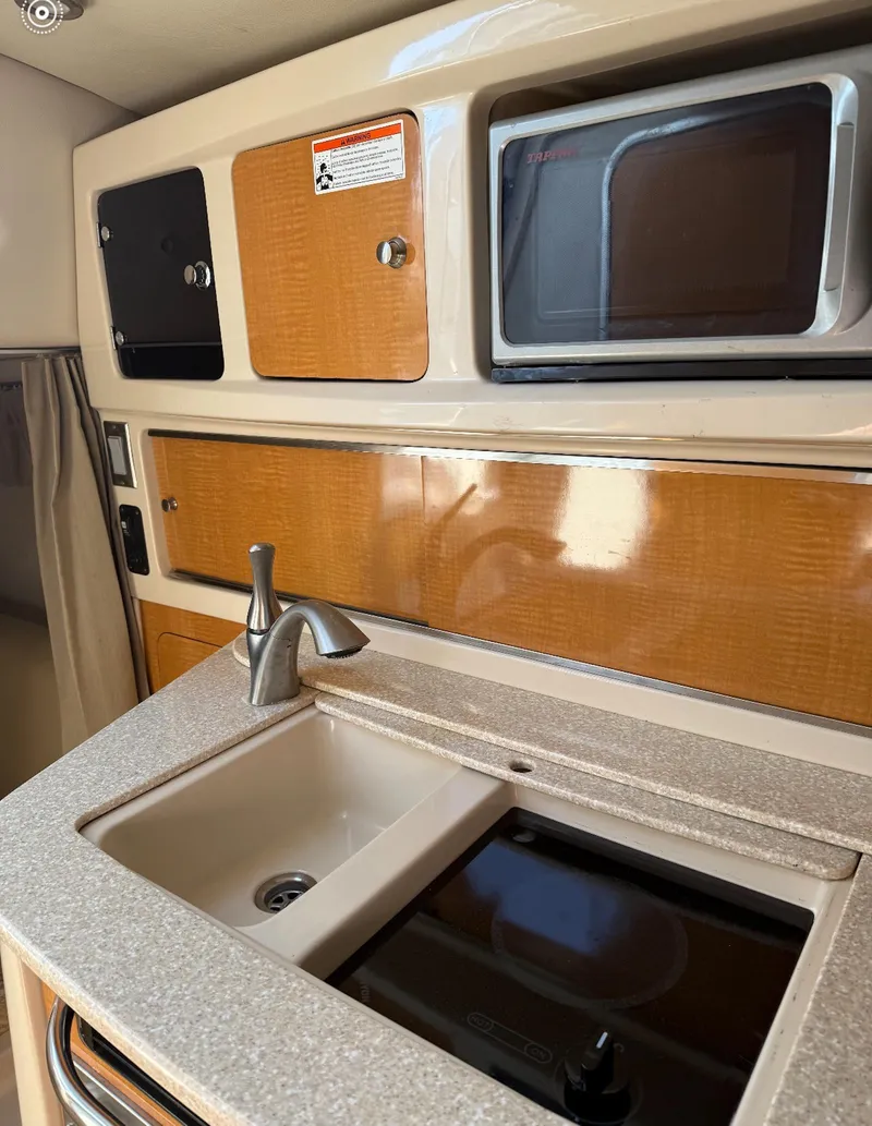 Slide: The Image of 2006 Chaparral Signature 276 interior kitchen with sink and stove. - 8
