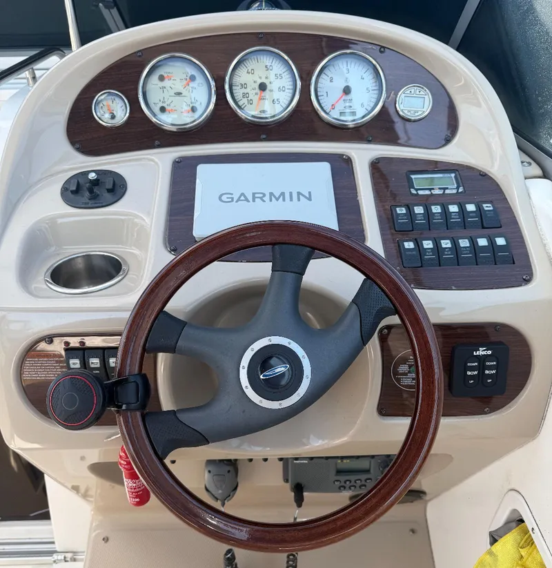 Slide: The Image of 2006 Chaparral Signature 276 dashboard with Garmin navigation and wood-trimmed steering wheel. - 5