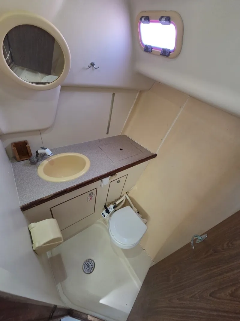 Slide: The Image of The image shows a boat bathroom with a sink, toilet, and shower area. - 9