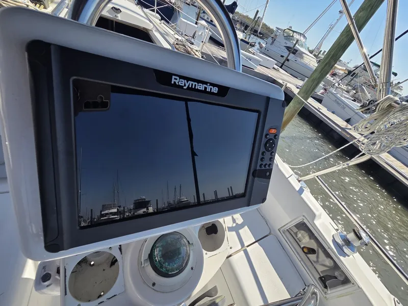 Slide: The Image of The image shows the cockpit of a 2005 Hunter 31 sailboat with a Raymarine display. - 12