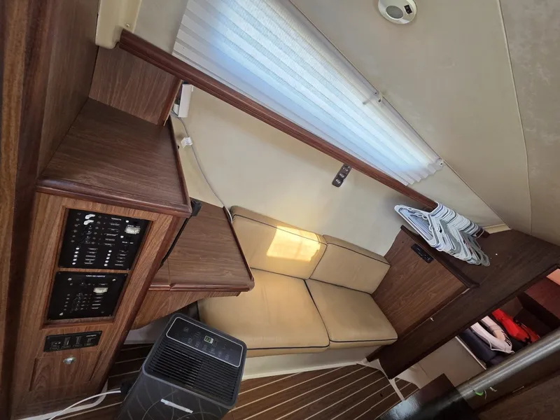 Slide: The Image of Interior of a 2005 Hunter 31 with a cozy seating area and wooden furnishings. - 4
