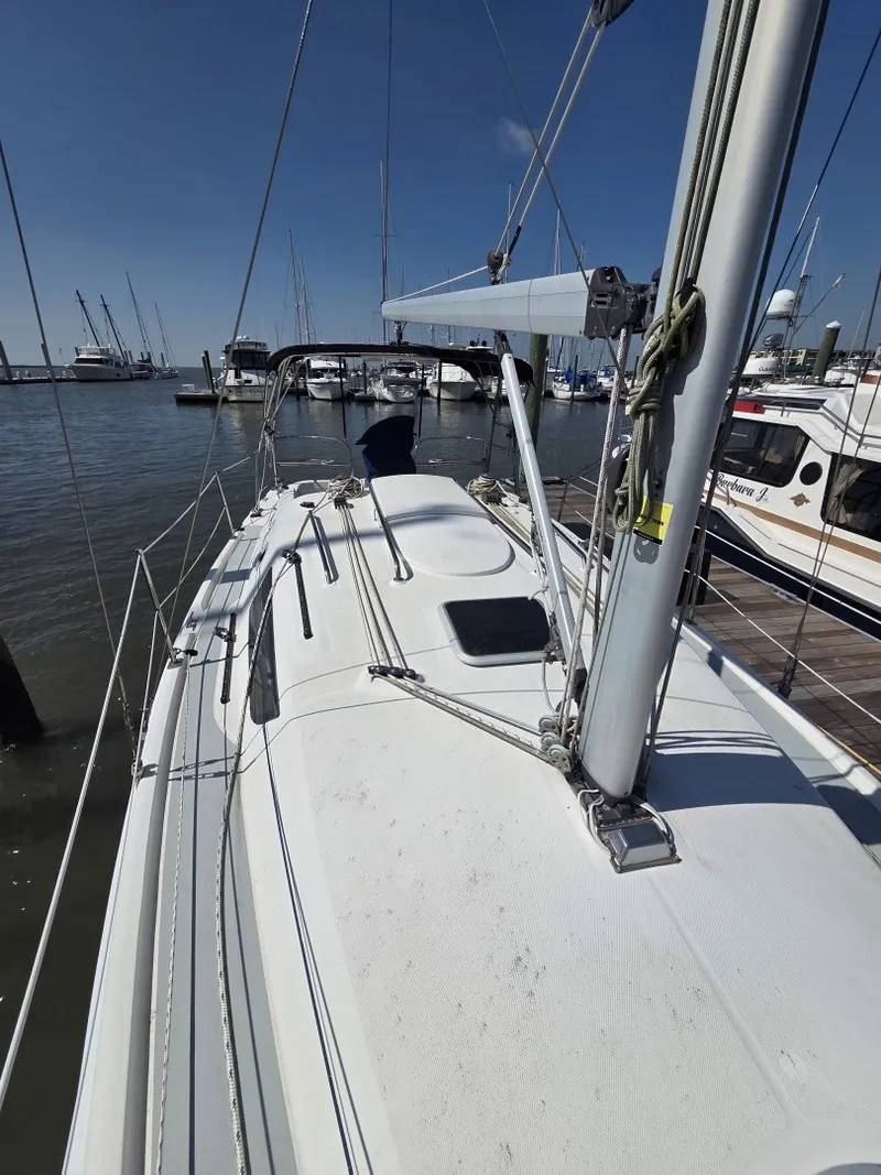 Slide: The Image of The image shows the deck of a 2005 Hunter 31 sailboat docked at a marina. - 23