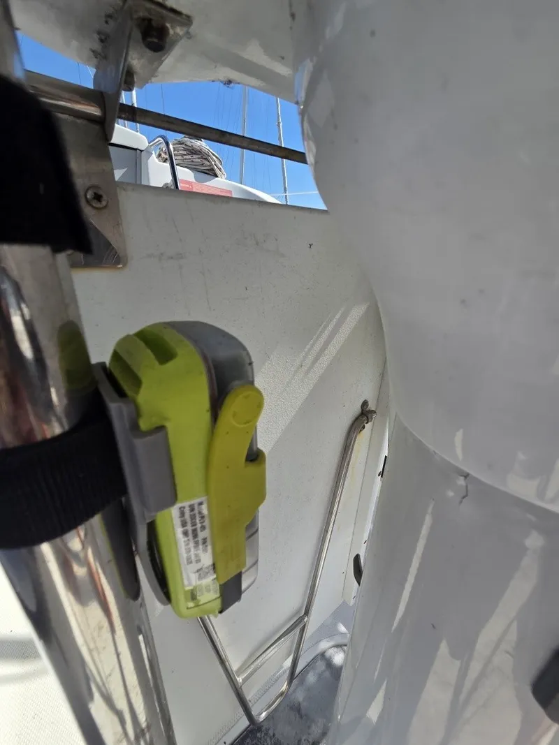 Slide: The Image of Close-up of a sailboat section with an attached device and metal railing. - 15