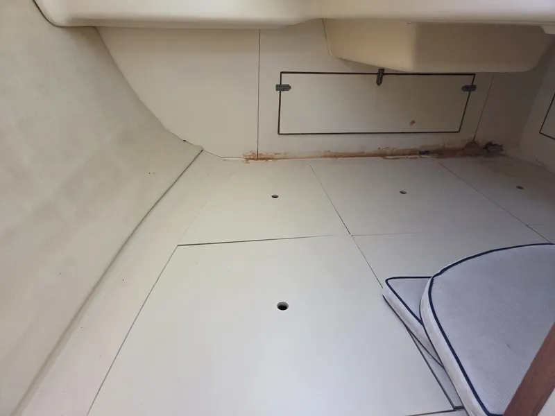 Slide: The Image of Interior of a 2005 Hunter 31 sailboat with storage compartments and cushions. - 8