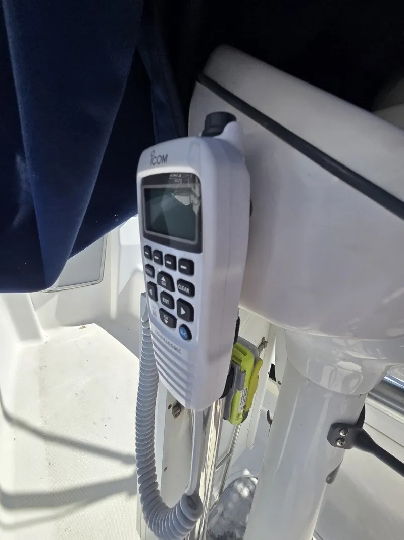 Slide: The Image of A radio is mounted on the helm console of a 2005 Hunter 31 boat. - 14