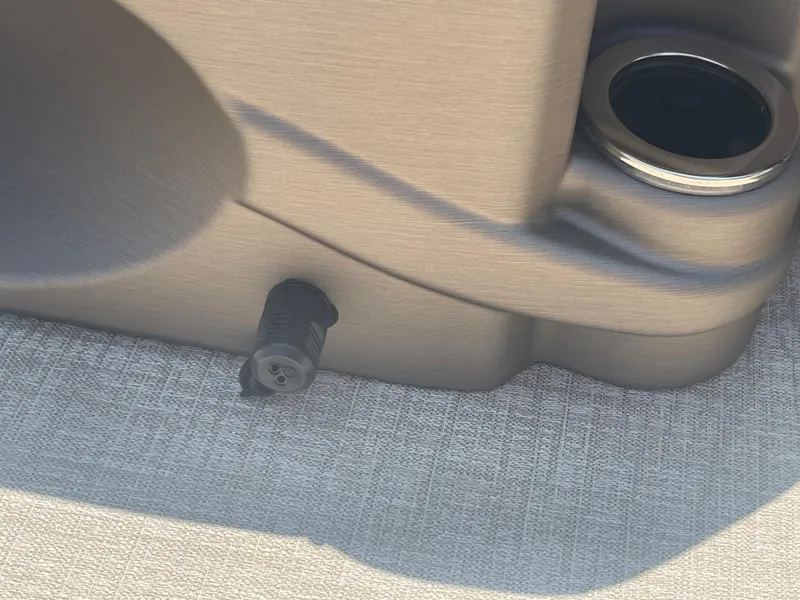 Slide: The Image of Close-up of a section of the 2024 Avalon LSZ Rear Fish with a cup holder and socket. - 32
