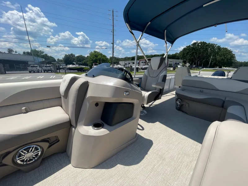 Slide: The Image of The image shows the interior of a 2024 Avalon LSZ Rear Fish boat with beige seating and a blue canopy. - 34
