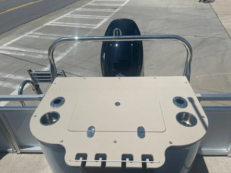 Slide: The Image of The image shows the rear of a 2024 Avalon LSZ Rear Fish boat with a fishing station and motor. - 29