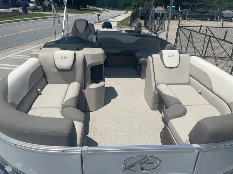 The Image of The image shows the interior of a 2024 Avalon LSZ Rear Fish pontoon boat with beige and gray seating. - 11