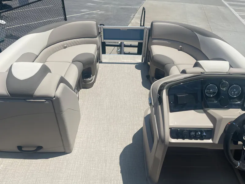 Slide: The Image of The image shows the cockpit and seating areas of a 2024 Avalon LSZ Rear Fish pontoon boat. The seats are beige. - 17