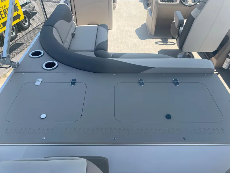 Slide: The Image of The image shows the rear of a 2024 Avalon LSZ Rear Fish boat with gray upholstery and cup holders. - 26
