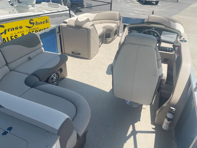 Slide: The Image of The image shows the interior of a 2024 Avalon LSZ Rear Fish pontoon boat with beige seating. - 31