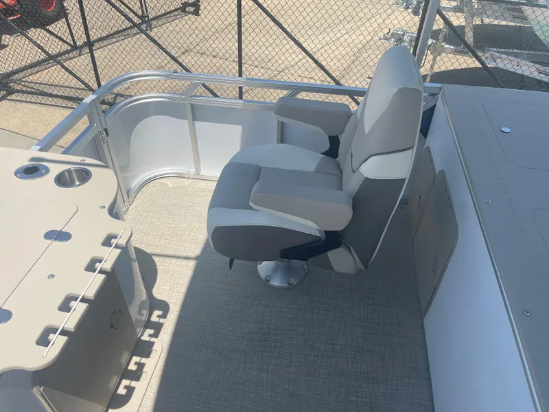 Slide: The Image of A modern seat on a boat with gray upholstery and a table with cup holders. - 22