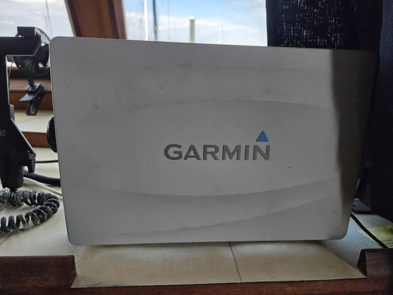 Slide: The Image of A Garmin navigation device is mounted on a boat, positioned near a window. - 37