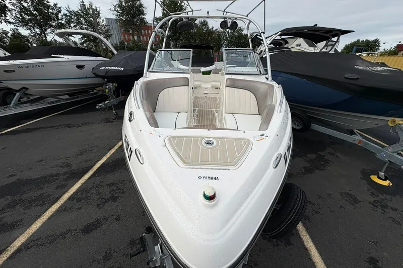 Slide: The Image of 2008 Yamaha Boats AR230 HO, white, parked on a trailer in a lot with other boats. - 2