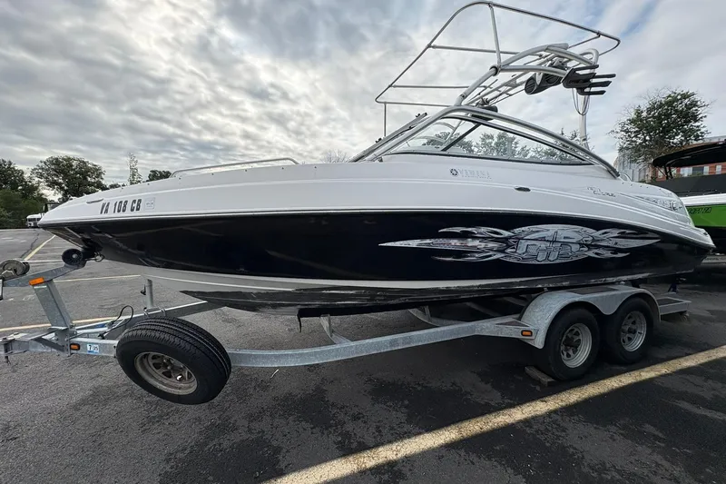 Slide: The Image of 2008 Yamaha Boats AR230 HO on trailer, parked outdoors under cloudy sky. - 1