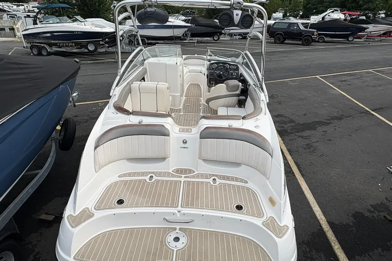Slide: The Image of 2008 Yamaha Boats AR230 HO with spacious seating and sleek design in a marina setting. - 3