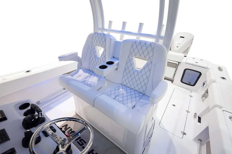Slide: The Image of Manufacturer Provided Image: 2025 Sportsman Open 322 Center Console interior with dual seats and steering wheel. - 22