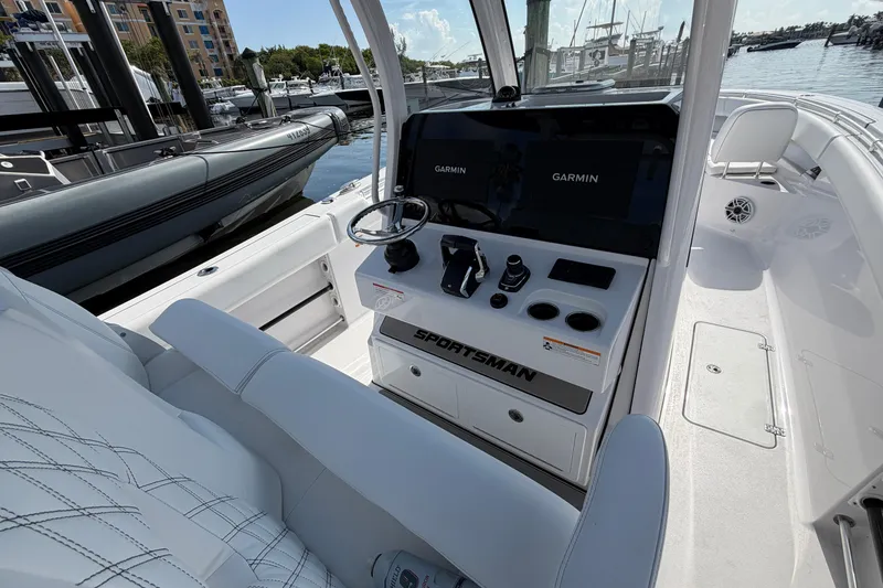 Slide: The Image of 2025 Sportsman Open 322 Center Console boat interior with Garmin displays at marina. - 3