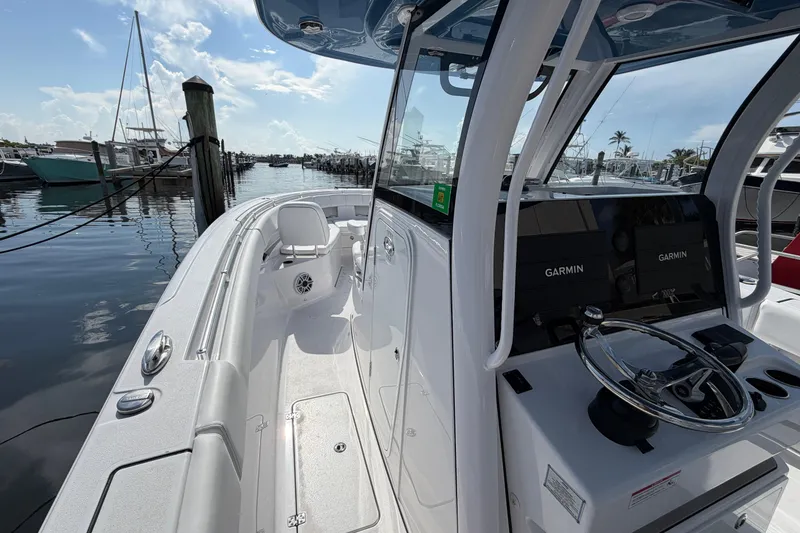 Slide: The Image of 2025 Sportsman Open 322 Center Console boat docked, featuring advanced Garmin navigation systems. - 5