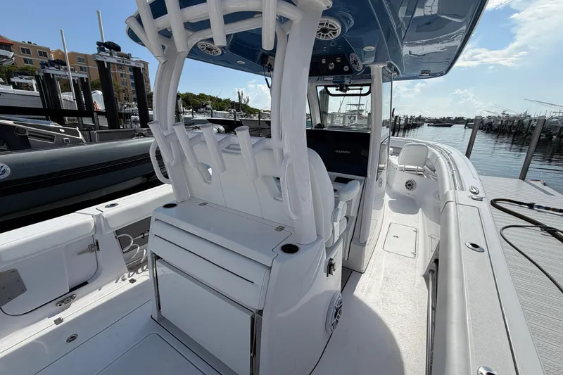 Slide: The Image of 2025 Sportsman Open 322 Center Console boat interior at marina, showcasing helm and seating. - 2