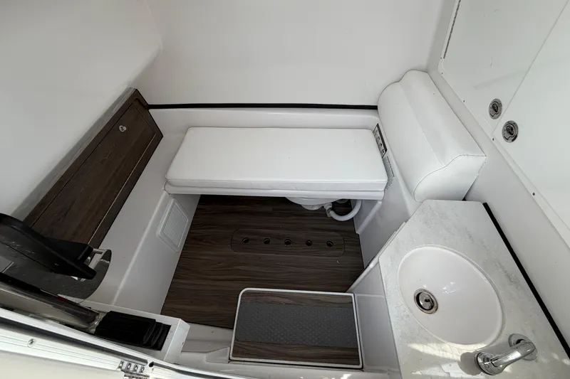 Slide: The Image of 2025 Sportsman Open 322 Center Console boat interior with sink and seating area. - 6