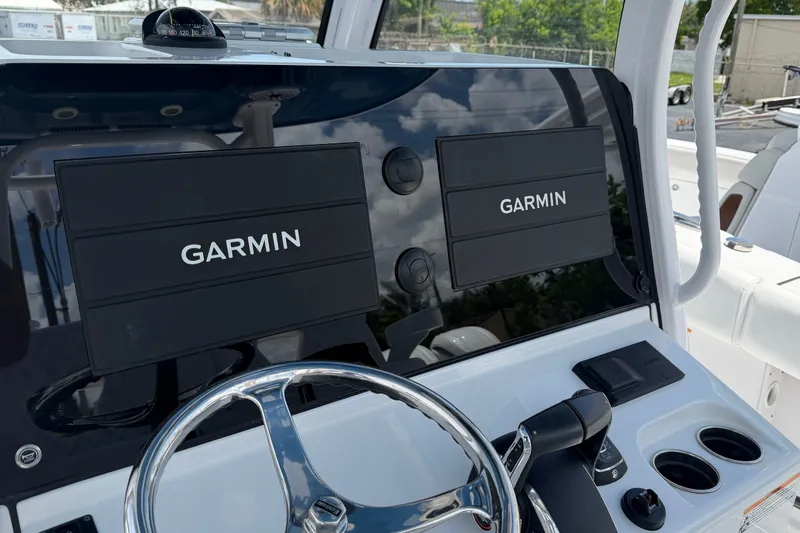 Slide: The Image of 2025 Sportsman Open 322 Center Console with dual Garmin displays and sleek steering wheel. - 10
