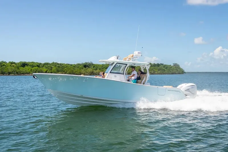Slide: The Image of Manufacturer Provided Image: 2025 Sportsman Open 322 Center Console boat cruising on a sunny day. - 9