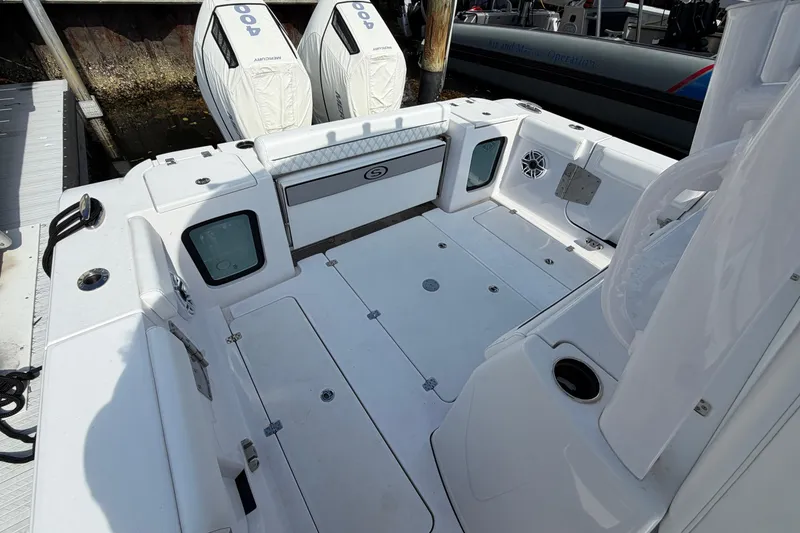 Slide: The Image of 2025 Sportsman Open 322 Center Console boat deck with twin outboard engines. - 1