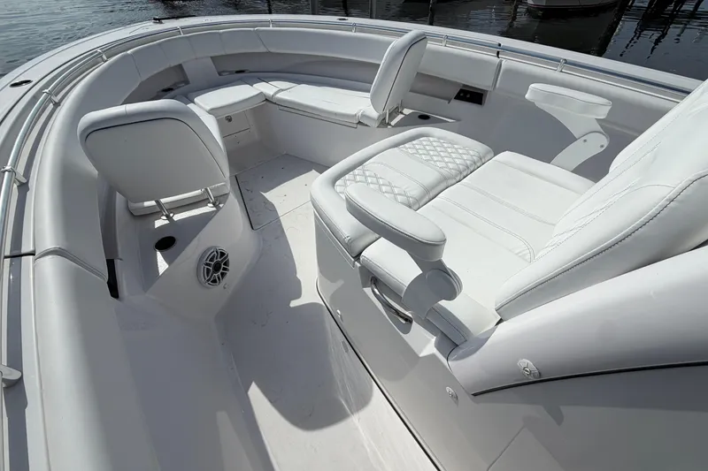 Slide: The Image of 2025 Sportsman Open 322 Center Console boat interior with luxurious white seating and modern design. - 7