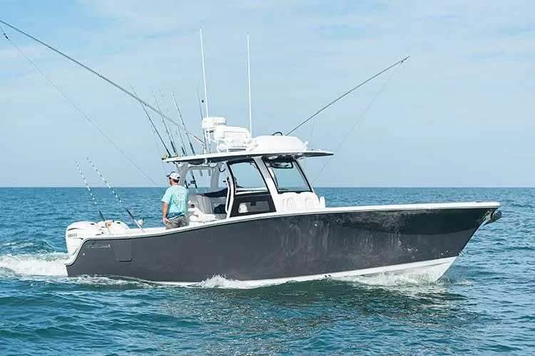 Slide: The Image of Manufacturer Provided Image: 2025 Sportsman Open 322 Center Console boat cruising on the ocean. - 13