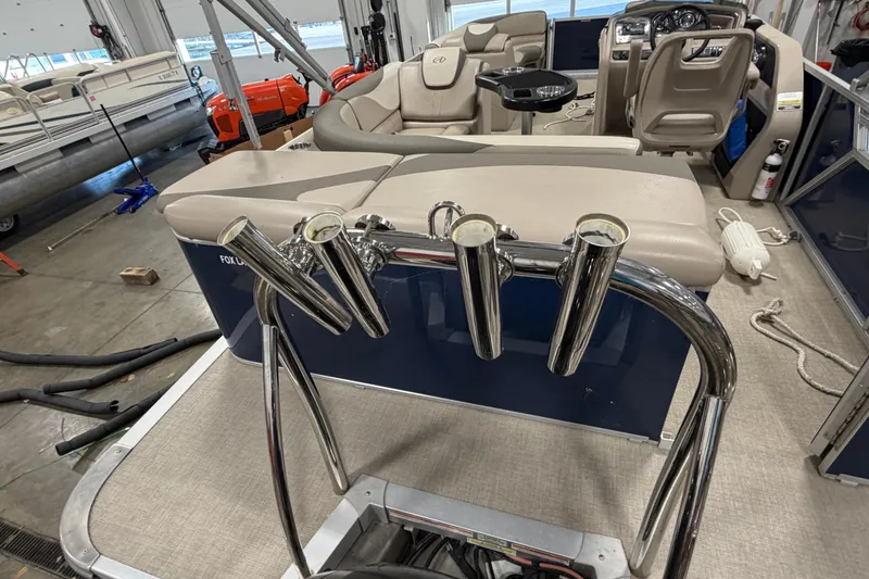Slide: The Image of 2022 Avalon LSZ 2285 CR pontoon boat interior with seating and rod holders. - 7