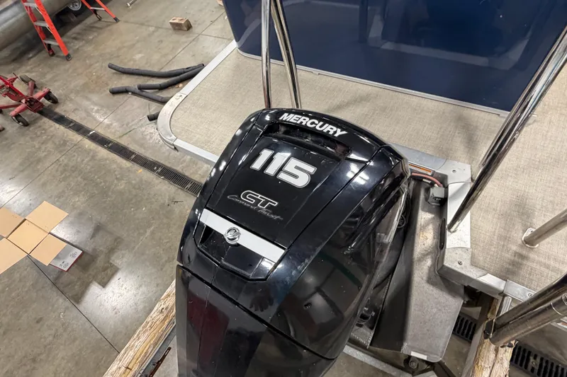 Slide: The Image of 2022 Avalon LSZ 2285 CR with Mercury 115 outboard motor in a workshop setting. - 9