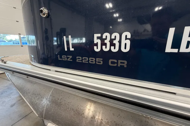 Slide: The Image of 2022 Avalon LSZ 2285 CR boat with registration number IL 5336 displayed indoors. - 3