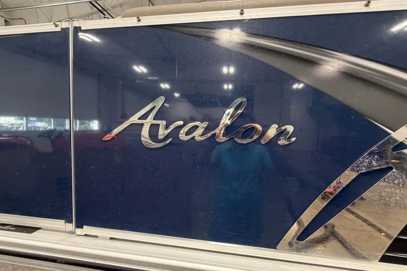 Slide: The Image of 2022 Avalon LSZ 2285 CR boat logo on a blue surface. - 2