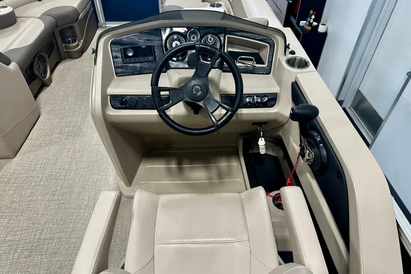 Slide: The Image of 2022 Avalon LSZ 2285 CR boat helm with steering wheel and control panel. - 16