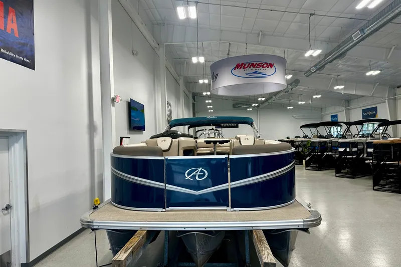 Slide: The Image of 2022 Avalon LSZ 2285 CR pontoon boat displayed in a showroom with bright lighting. - 13