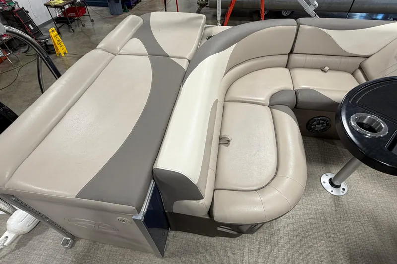 Slide: The Image of 2022 Avalon LSZ 2285 CR pontoon boat interior with beige seating and black table. - 8