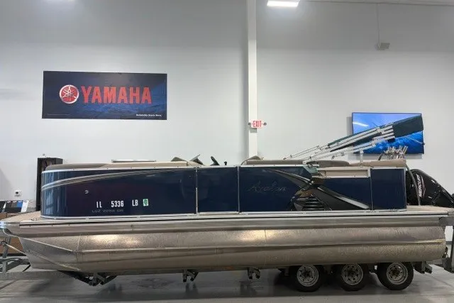 Slide: The Image of 2022 Avalon LSZ 2285 CR pontoon boat on trailer in showroom with Yamaha sign. - 3