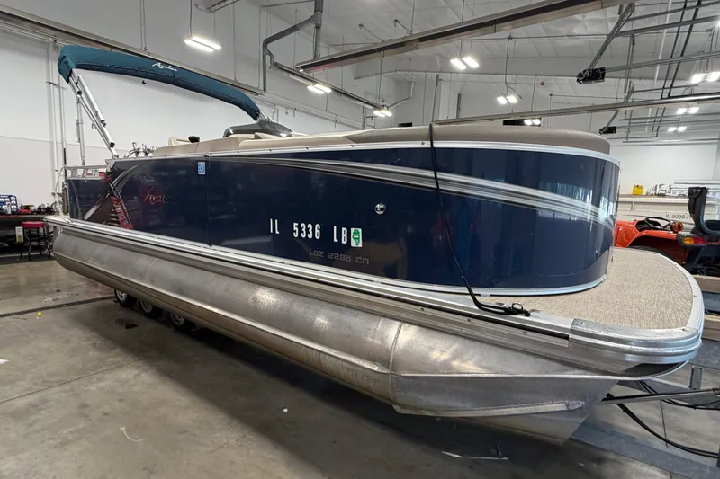 Slide: The Image of 2022 Avalon LSZ 2285 CR pontoon boat in a warehouse setting. - 5
